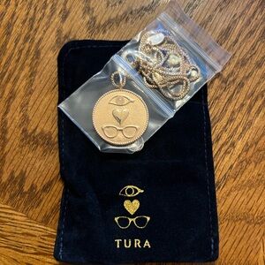 Brand new, gold eye/ eyeglasses coin necklace with necklace pouch.